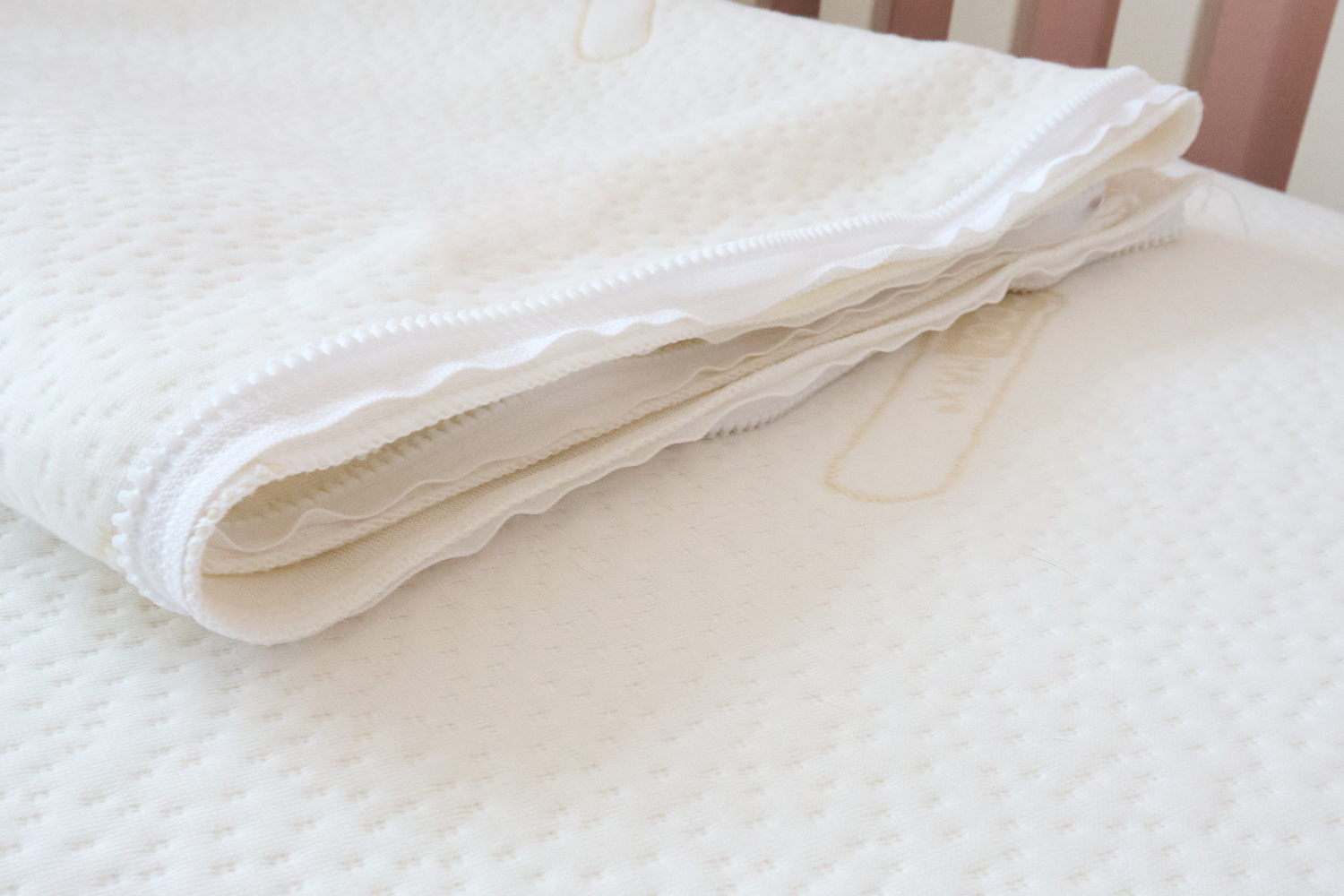 Two Coolmax toppers folded on a cot mattress