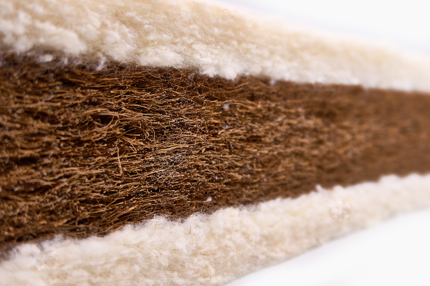 Cross-section of mattress core showing natural coir and lambswool layers